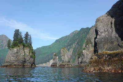 Scenic view of sea and mountains against sky