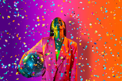 Man holding multi colored umbrella