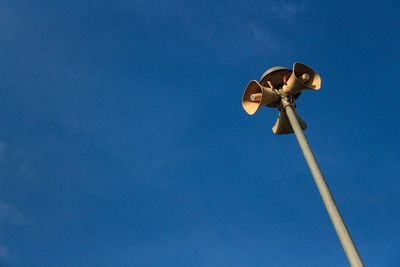 Low angle view of street light against clear blue sky