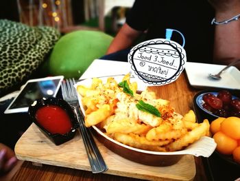 Close-up of hand holding food on table