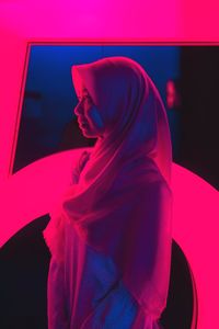 Close-up of a beautiful young woman over red background