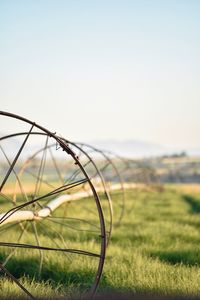 Barbed wire on field against sky