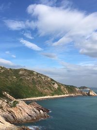 Scenic view of sea and mountains against sky