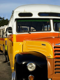 Close-up of yellow car against sky