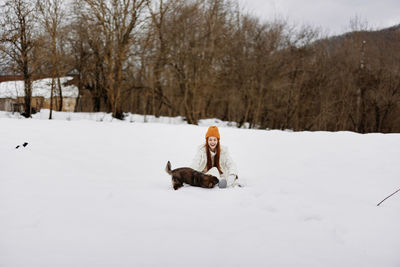 Dog running on snow covered field