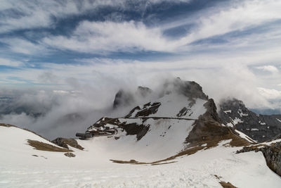 Scenic view of snow covered mountains against sky