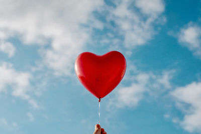 Low angle view of balloons against sky