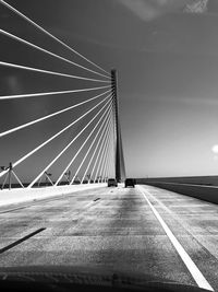 Low angle view of suspension bridge against sky