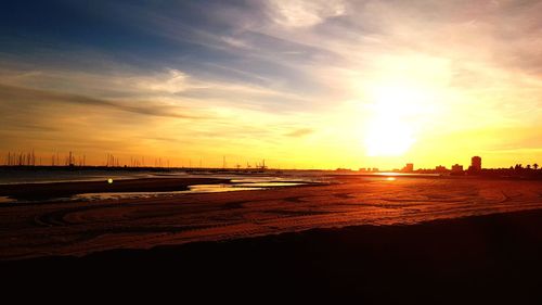 Scenic view of beach against sky during sunset