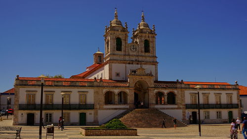 View of historic building against clear blue sky