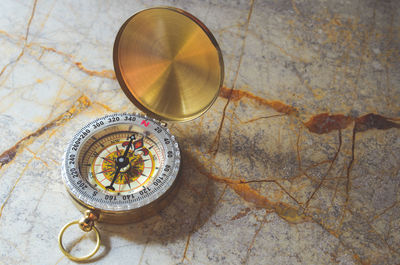 High angle view of navigational compass on table