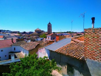 High angle shot of townscape against blue sky