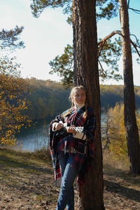 Portrait of young woman standing on field