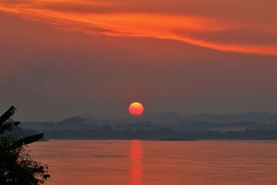 Scenic view of sea against romantic sky at sunset