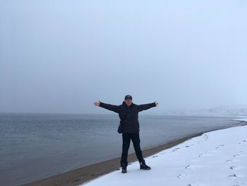 Full length of man standing on snow