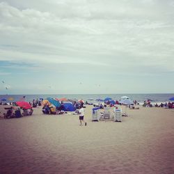 People on beach against sky