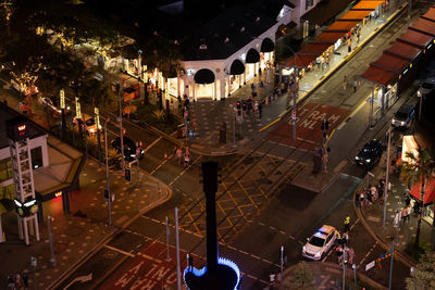 High angle view of people walking on road at night