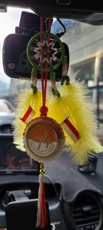 Low angle view of decoration hanging in car