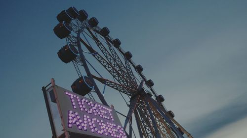 Low angle view of ferris wheel against sky