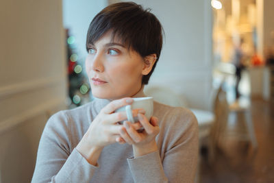 Thoughtful woman sitting in cafe