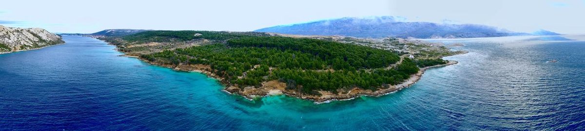 Panoramic view of sea and mountains against sky