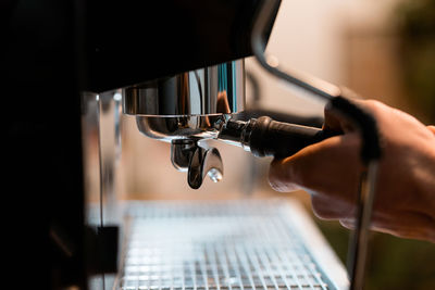 Close-up of man working in machine