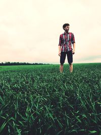 Full length of man standing on field against sky