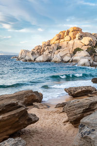 Rocks on beach against sky