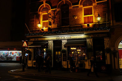 People at illuminated city at night