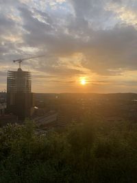 Scenic view of buildings against sky during sunset