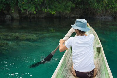 Young woman fishing in sea