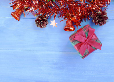 Directly above shot of christmas decorations and gifts on blue wooden floor