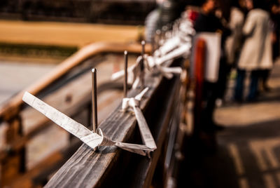 Close-up of paper on railing