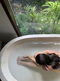 High angle view of woman standing in bathroom