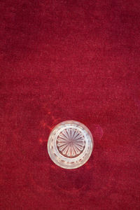 High angle view of ring on red background