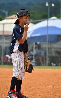 Side view of young man playing with umbrella