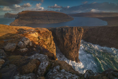 Rock formations by sea against sky