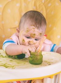 High angle view of cute boy eating food at home