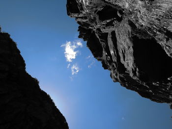 Low angle view of mountain against blue sky