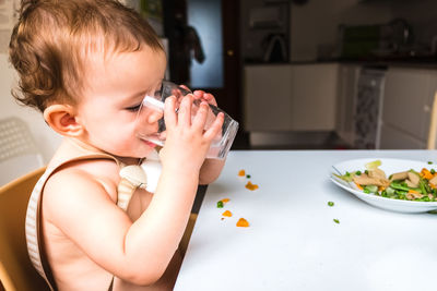 Cute baby girl on table at home