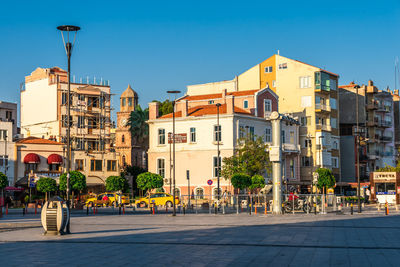 Buildings in city against clear sky