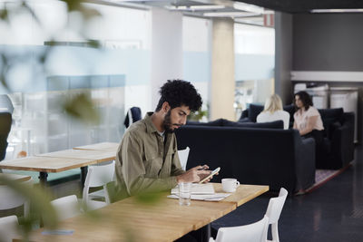 Man working solitary in office cafeteria