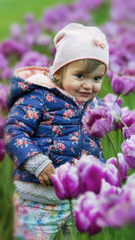 Close-up of hand holding pink flower