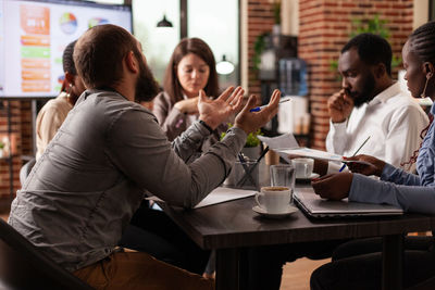 Friends using mobile phone at restaurant