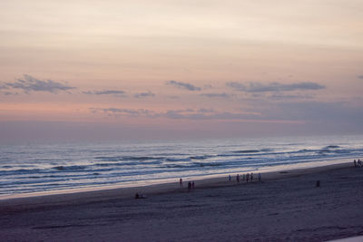 Scenic view of beach against sky during sunset