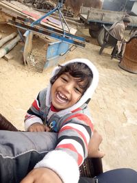 Portrait of smiling boy sitting outdoors