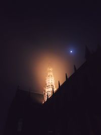 Low angle view of illuminated building against sky at night