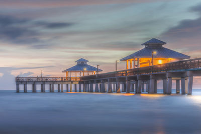 Built structure in sea against cloudy sky