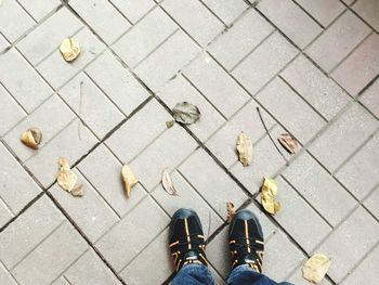 Low section of man standing on sidewalk