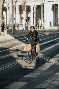 Man riding bicycle on street in city